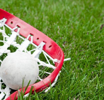 Lacrosse stick and ball on field