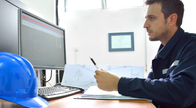 Commercial Contractor Working at office Desk