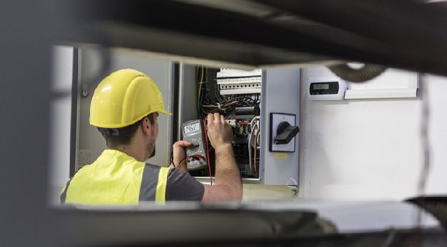 Electrician working on power box