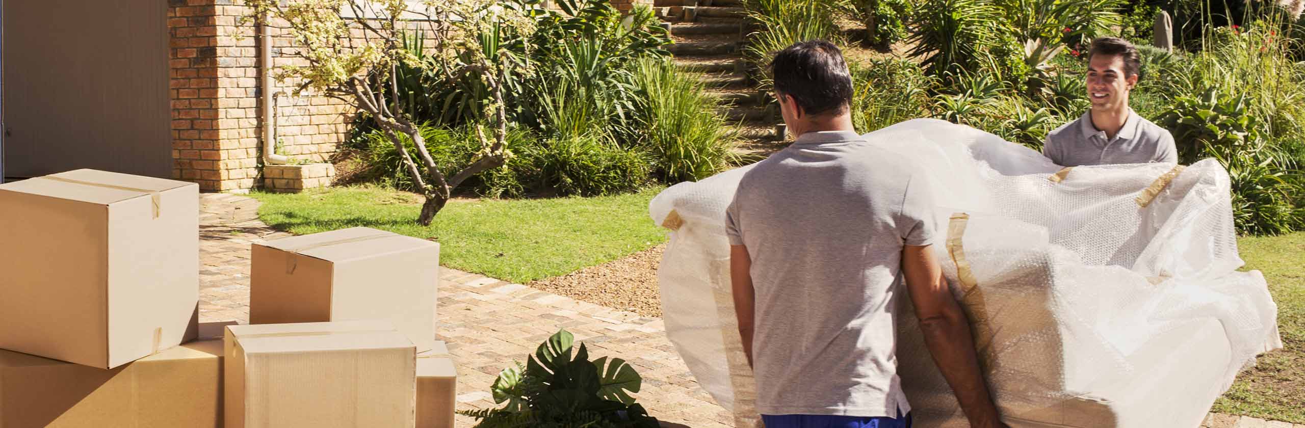 Two professionals moving a couch